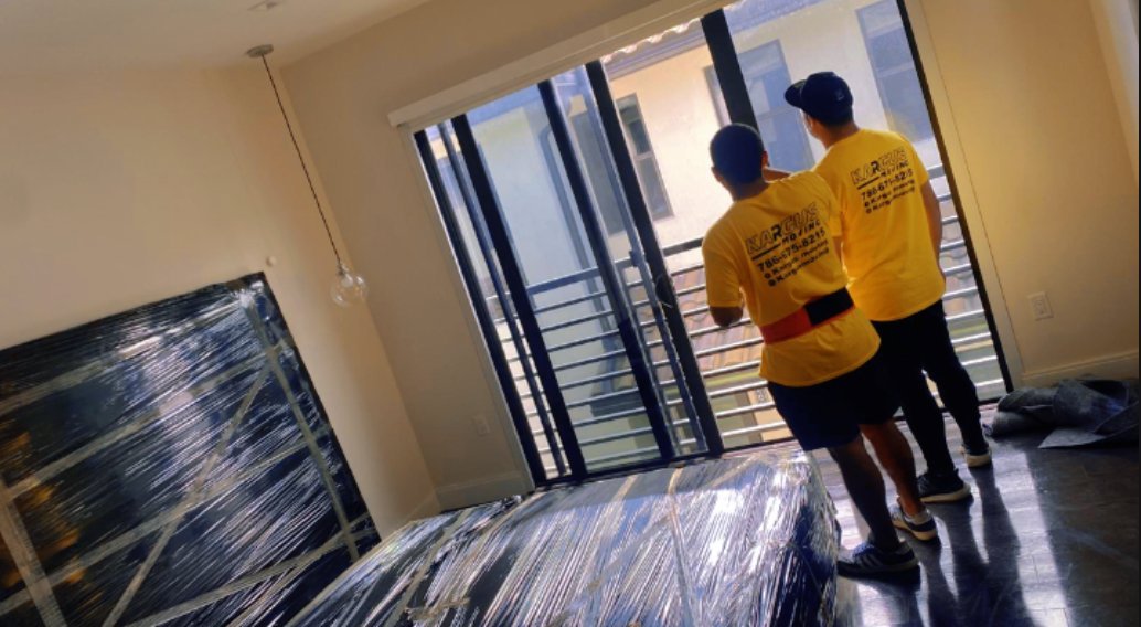 Kargus team in yellow shirts carrying sofa in Miami